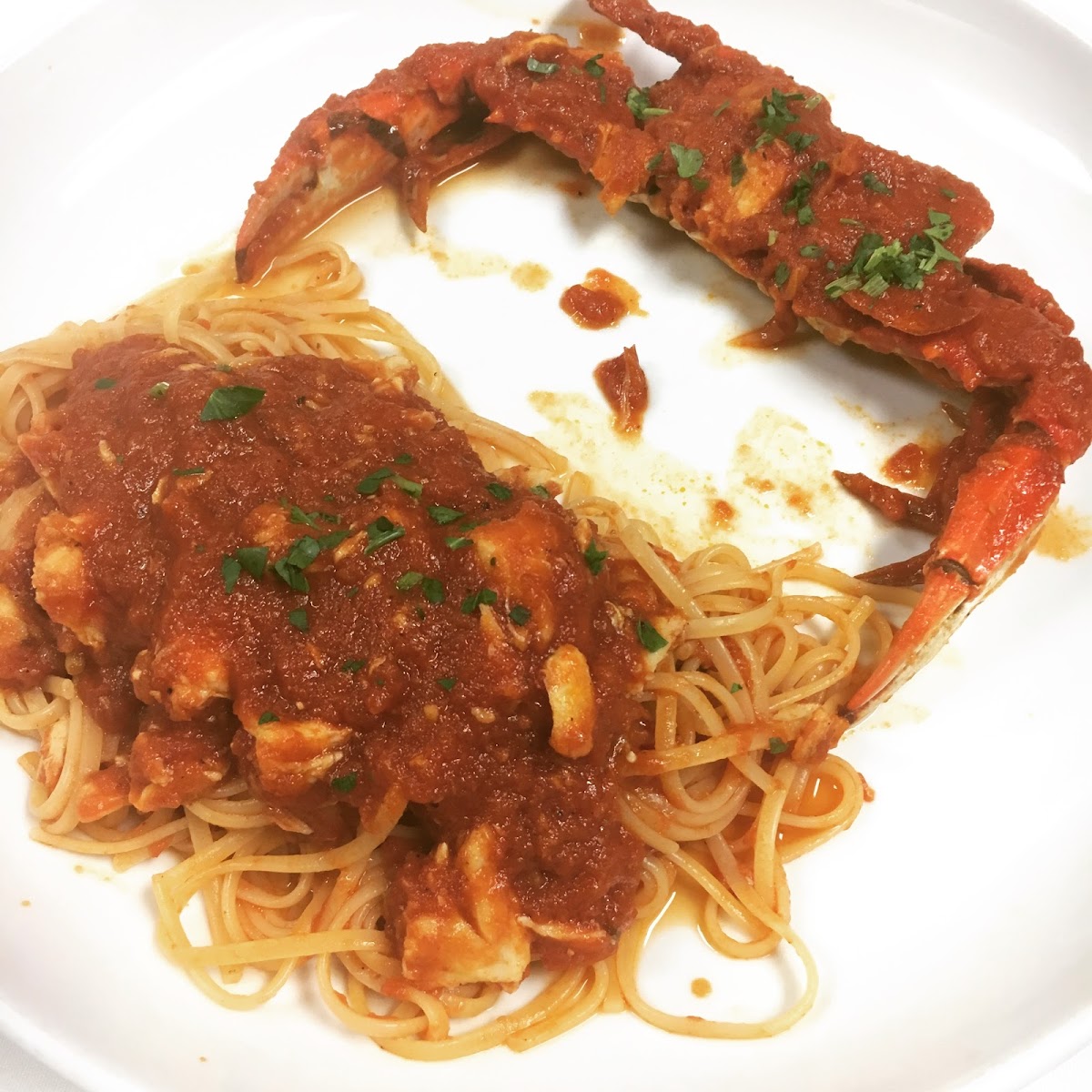 Linguine with crab in red sauce, with full crab claw on top